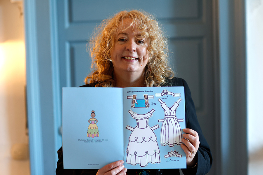 Carmel Grant Designs finlalist in the Business of Crafts Awards at Showcase 2026 holding her Dance Star Paper Doll Book