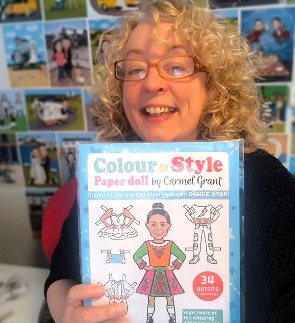 Irish artist Carmel Grant with one of her Paper Doll Books, the ideal creative colouring activity gifts for girls and boys aged 5 to 12 years and older.