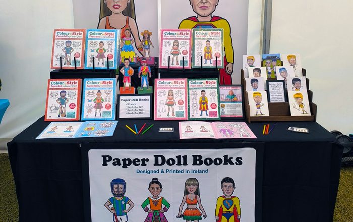 Paper Doll Books and caricature greeting cards by Carmel Grant Designs for sale at market stall